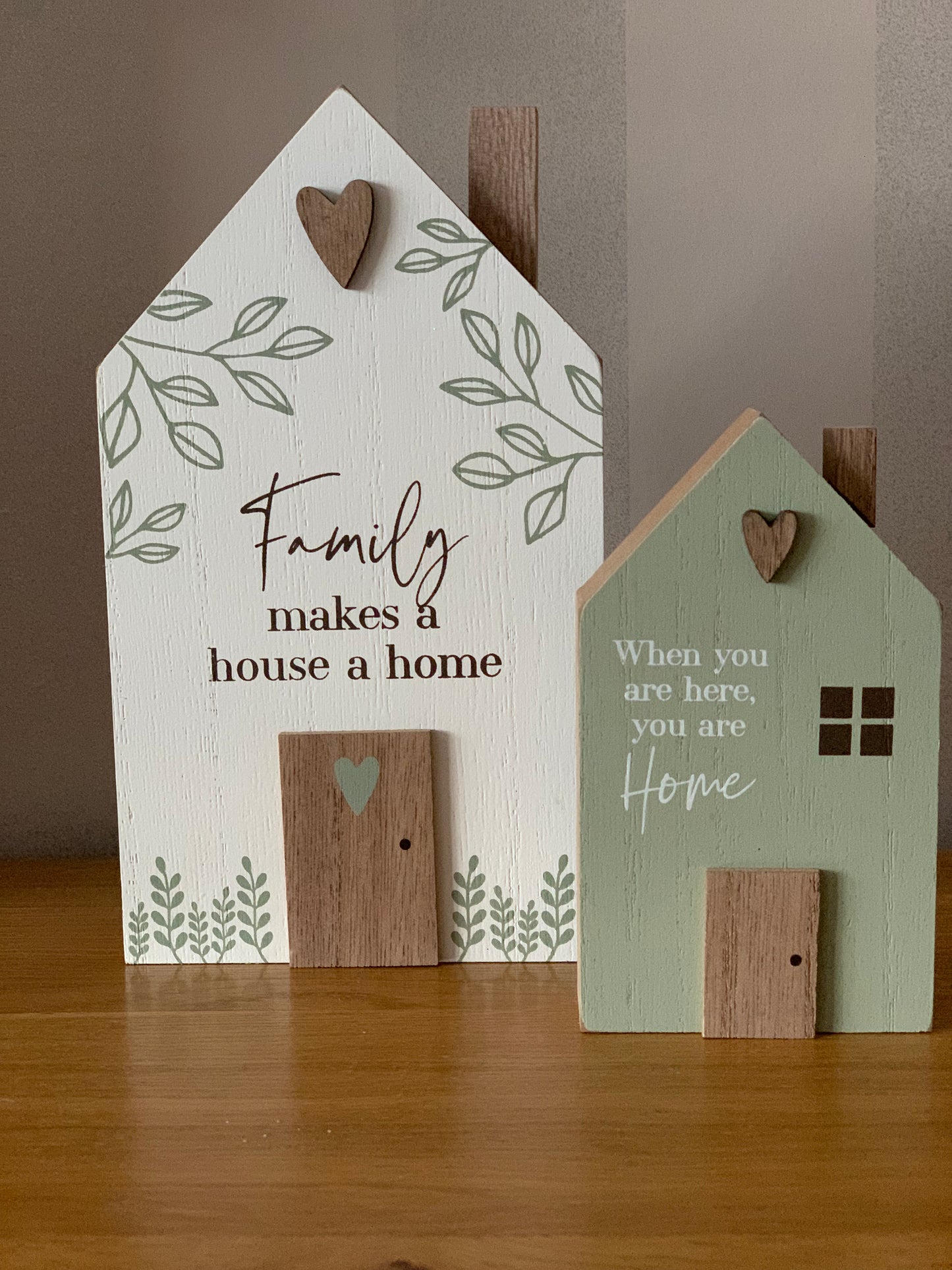 Family makes a house a home sign