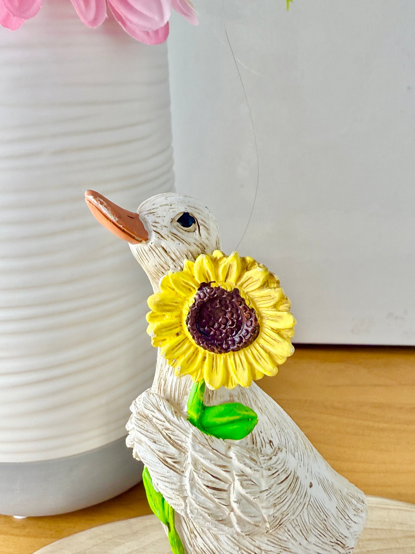 Duck wearing yellow wellington boots & sunflower