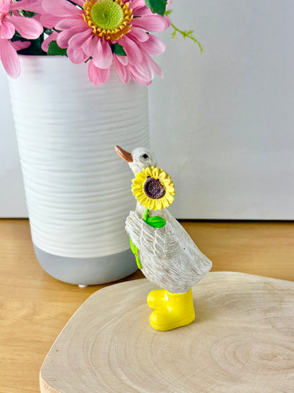Duck wearing yellow wellington boots & sunflower