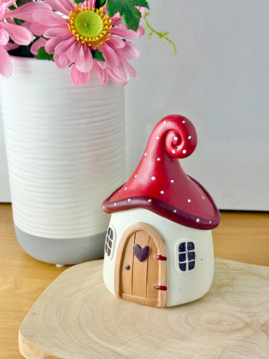 Mushroom house with red polka dot roof & heart door