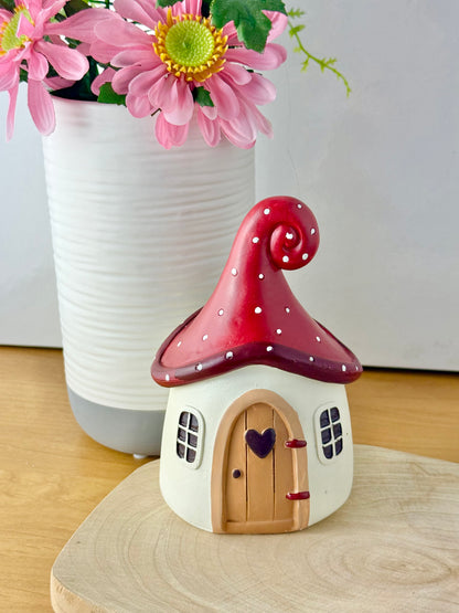 Mushroom house with red polka dot roof & heart door