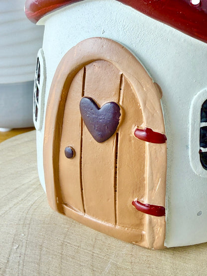 Mushroom house with red polka dot roof & heart door