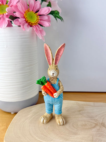 Jasper Rabbit holding a bunch of carrots