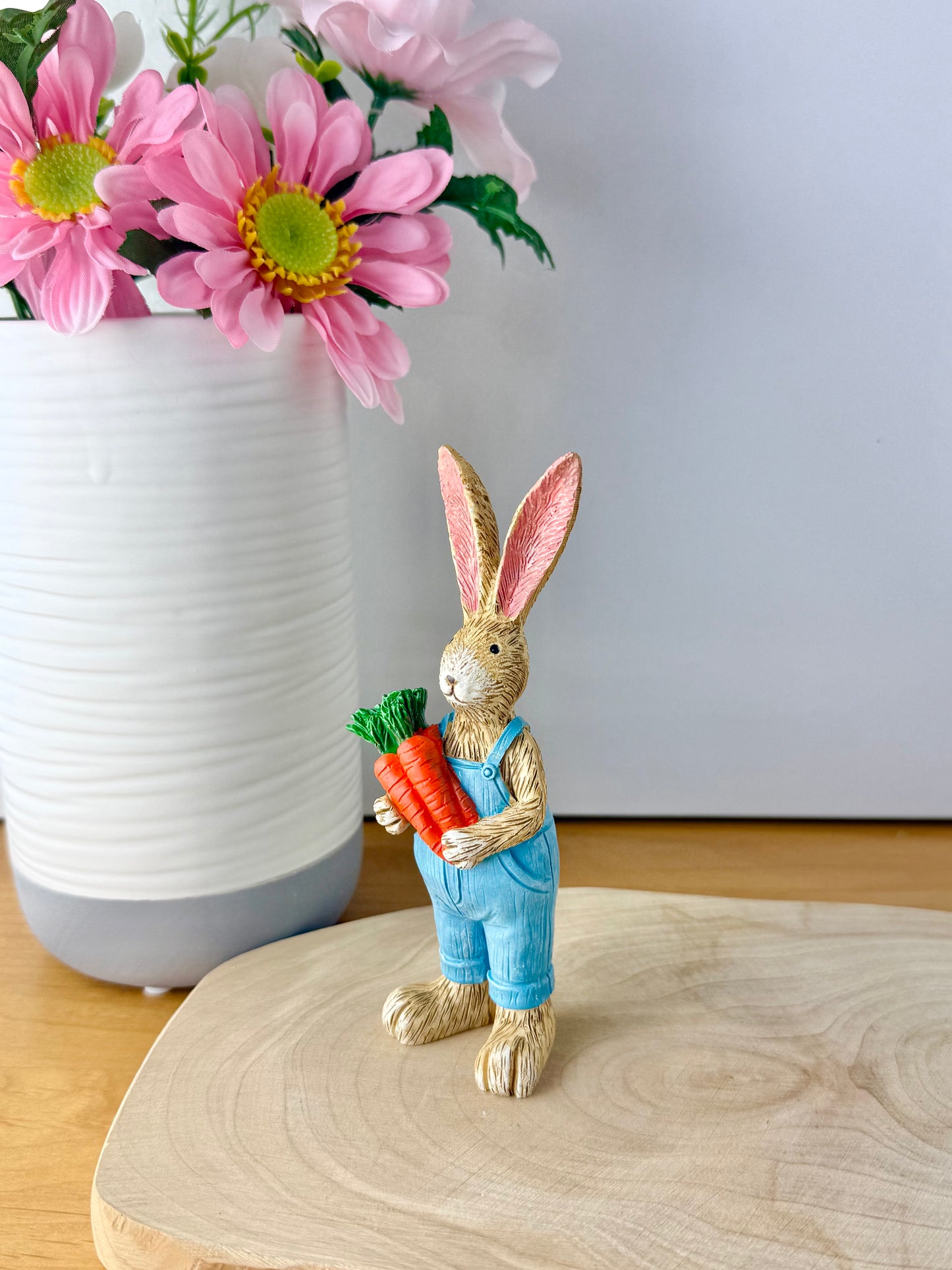 Jasper Rabbit holding a bunch of carrots
