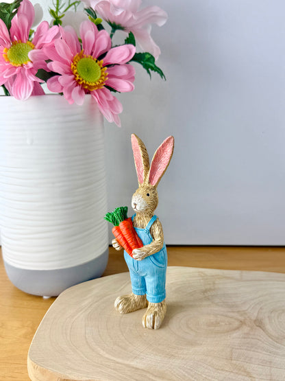 Jasper Rabbit holding a bunch of carrots