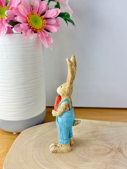 Jasper Rabbit holding a bunch of carrots