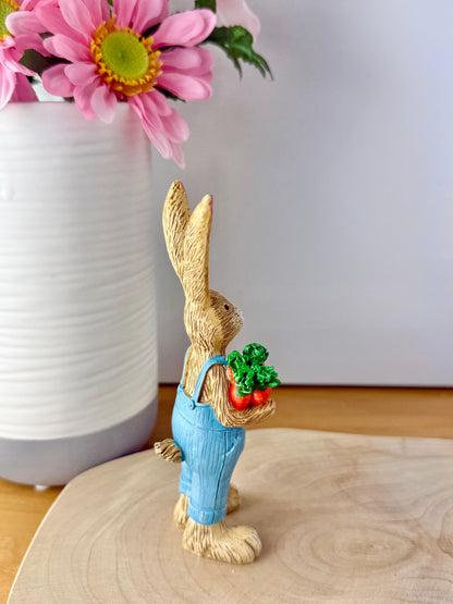 Jasper Rabbit holding a bunch of carrots