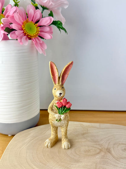 Jasper Rabbit holding a bunch of pink tulips from the Jasper Rabbit Collection