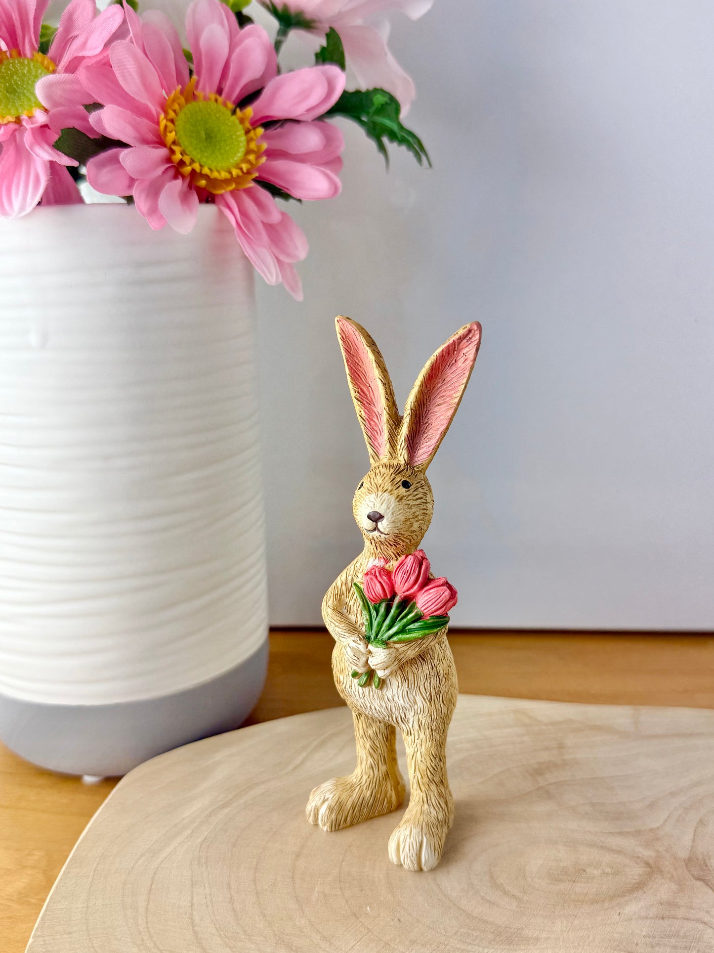 Jasper Rabbit holding a bunch of pink tulips from the Jasper Rabbit Collection