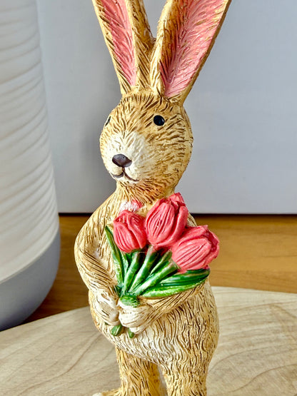 Jasper Rabbit holding a bunch of pink tulips from the Jasper Rabbit Collection