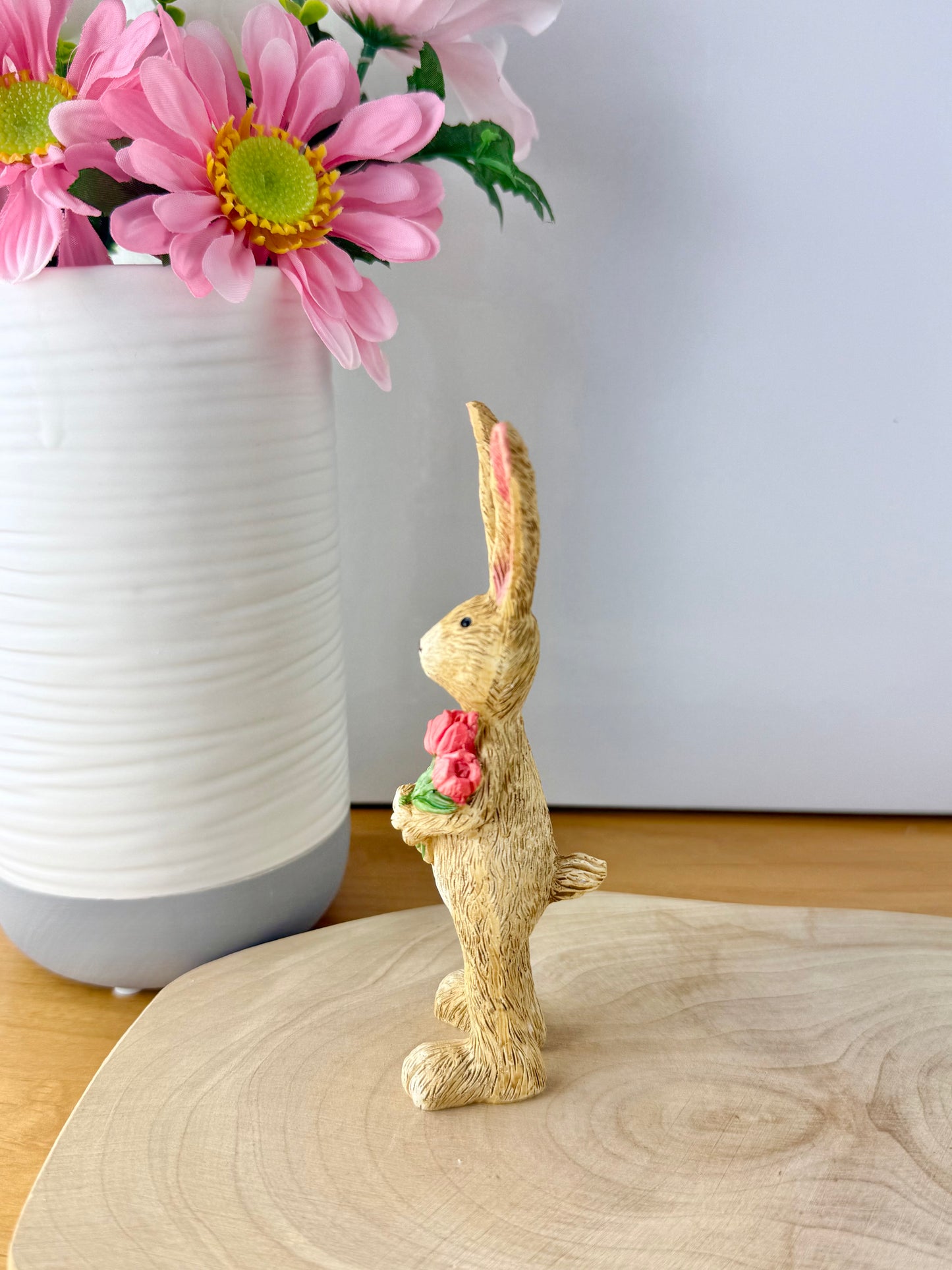 Jasper Rabbit holding a bunch of pink tulips from the Jasper Rabbit Collection