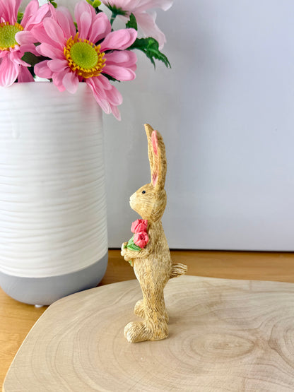 Jasper Rabbit holding a bunch of pink tulips from the Jasper Rabbit Collection