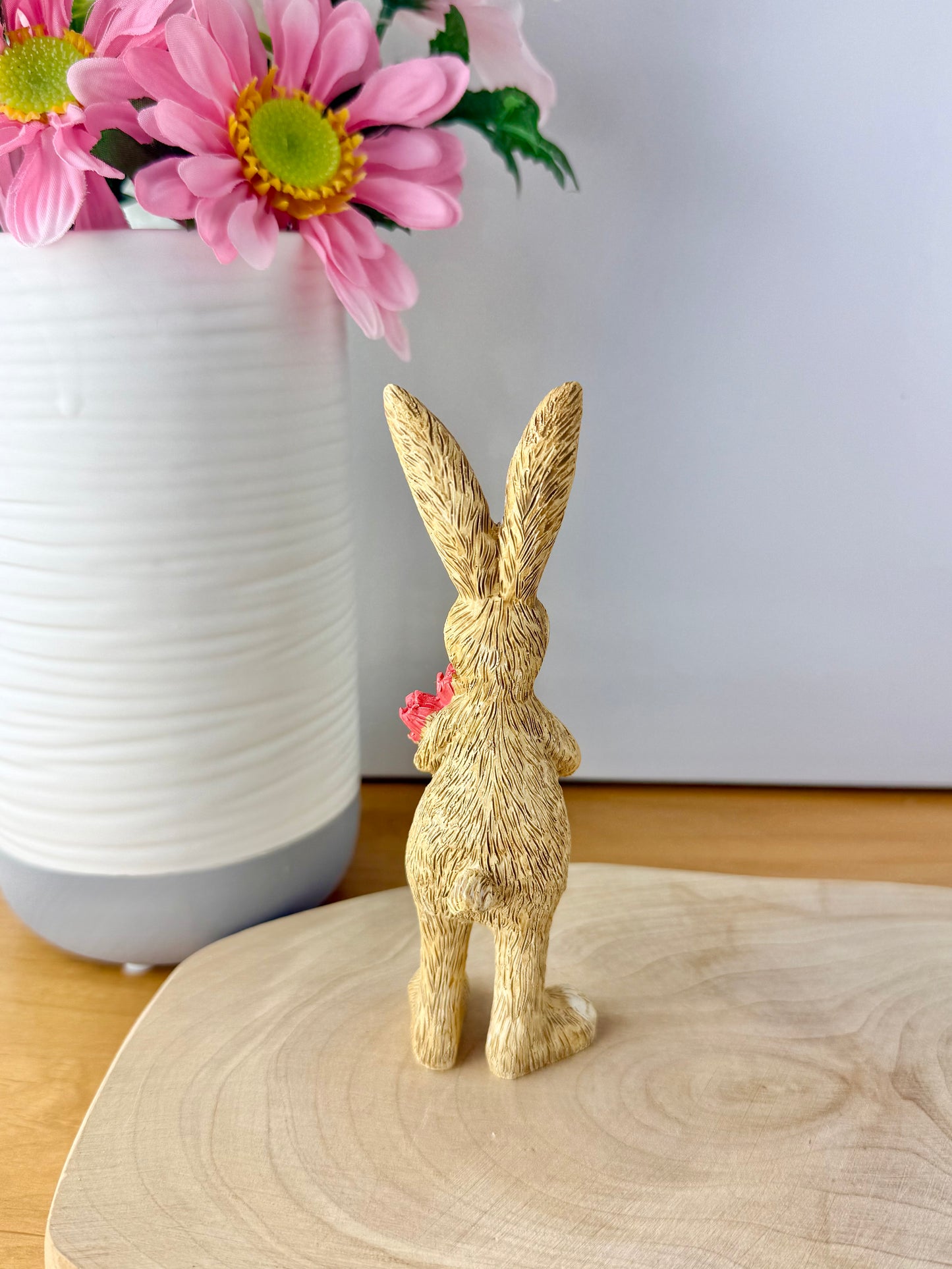 Jasper Rabbit holding a bunch of pink tulips from the Jasper Rabbit Collection