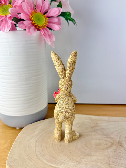 Jasper Rabbit holding a bunch of pink tulips from the Jasper Rabbit Collection