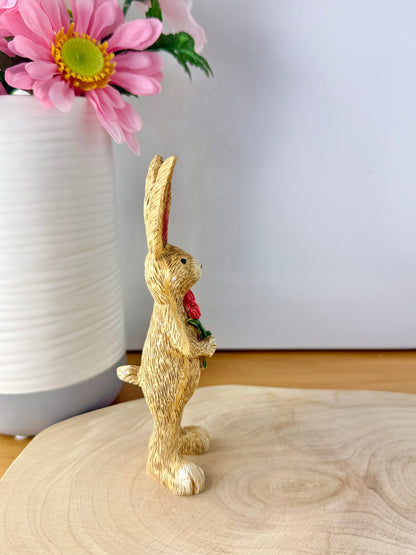 Jasper Rabbit holding a bunch of pink tulips from the Jasper Rabbit Collection