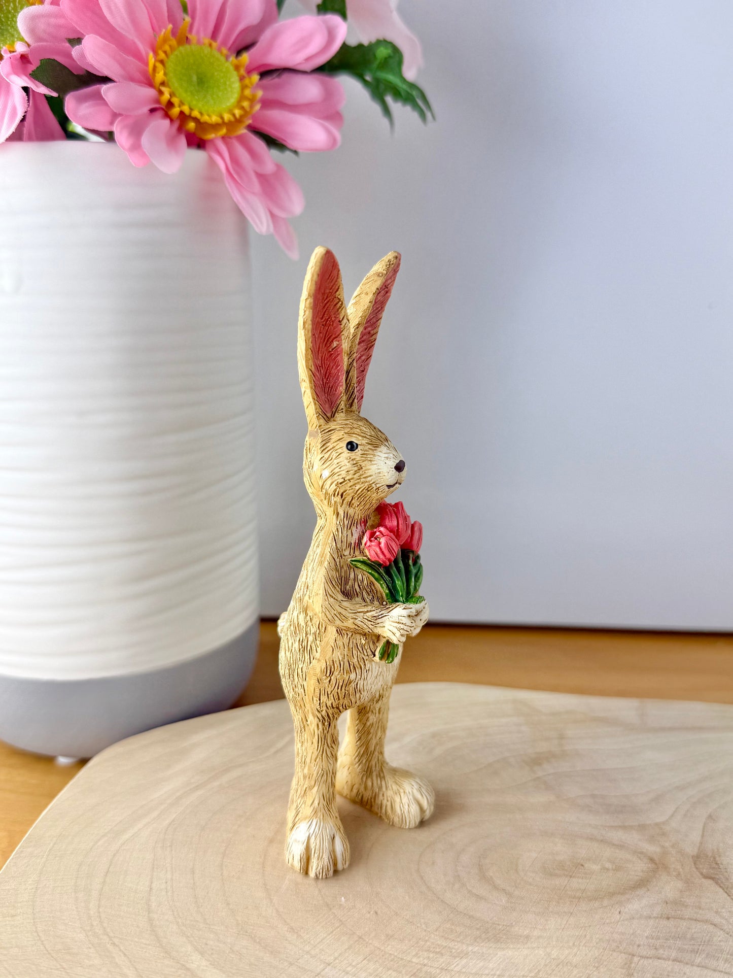 Jasper Rabbit holding a bunch of pink tulips from the Jasper Rabbit Collection