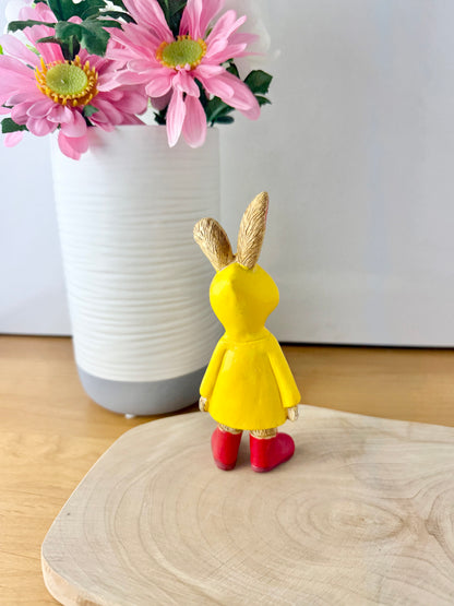 Jasper Rabbit dressed for the rain in a yellow raincoat & red wellies