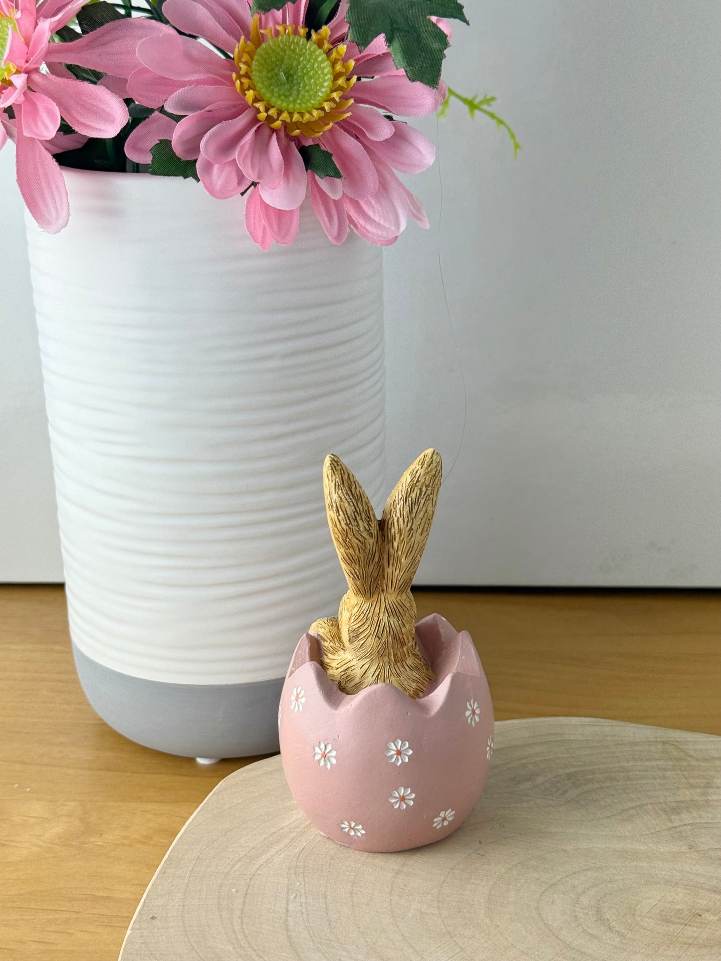 Jasper Rabbit sitting inside a pink daisy egg