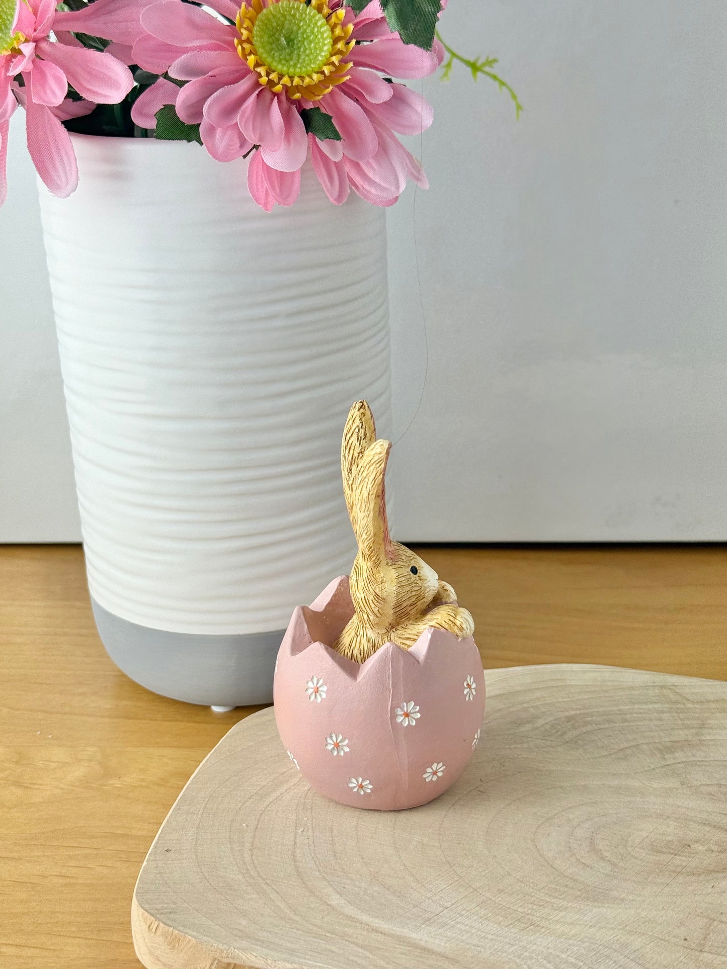 Jasper Rabbit sitting inside a pink daisy egg