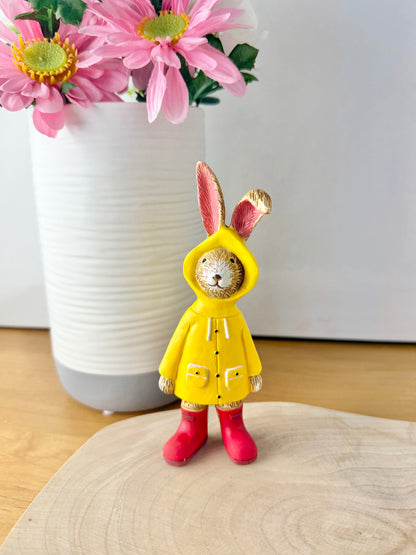 Jasper Rabbit dressed for the rain in a yellow raincoat & red wellies