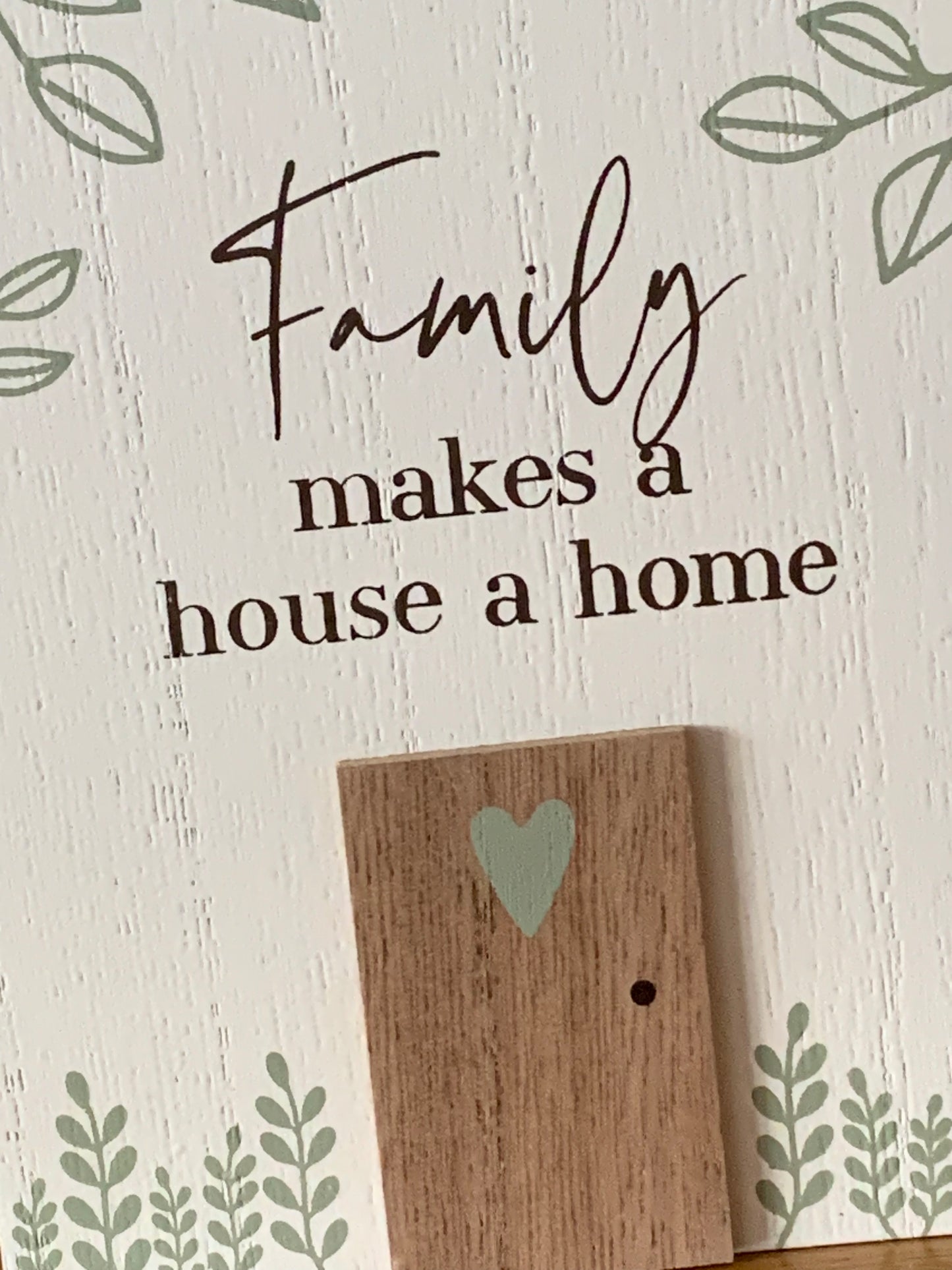 Family makes a house a home sign