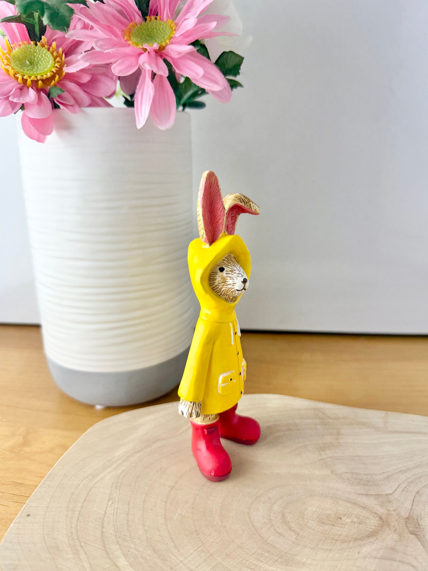 Jasper Rabbit dressed for the rain in a yellow raincoat & red wellies