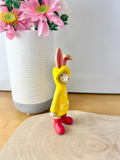 Jasper Rabbit dressed for the rain in a yellow raincoat & red wellies