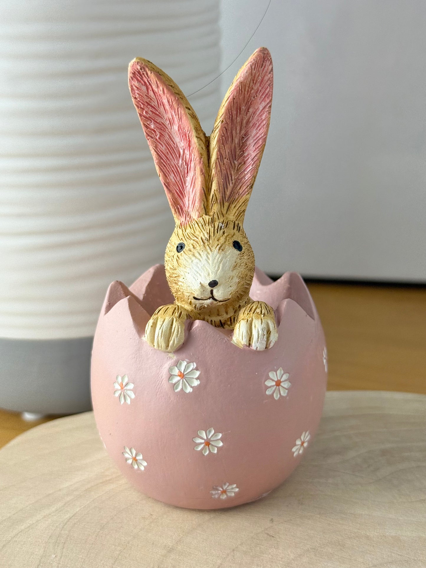 Jasper Rabbit sitting inside a pink daisy egg