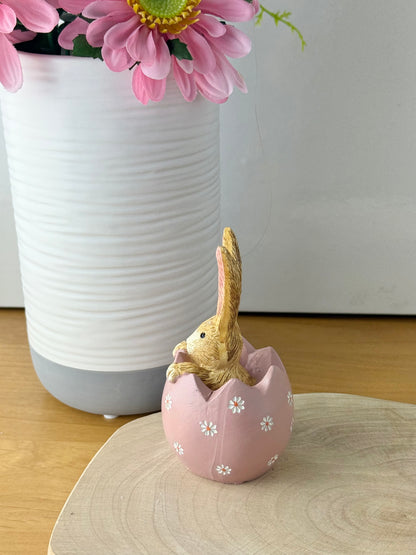 Jasper Rabbit sitting inside a pink daisy egg