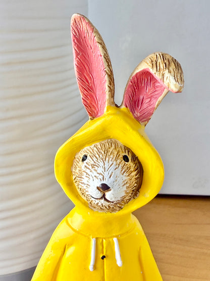 Jasper Rabbit dressed for the rain in a yellow raincoat & red wellies